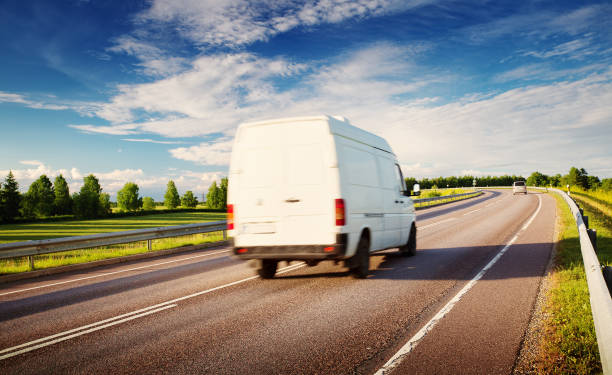 istock asphalt road on dandelion field 870489200