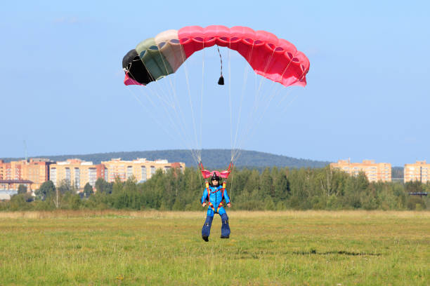 istock skydiver landed on  green field on  summer day 870493024