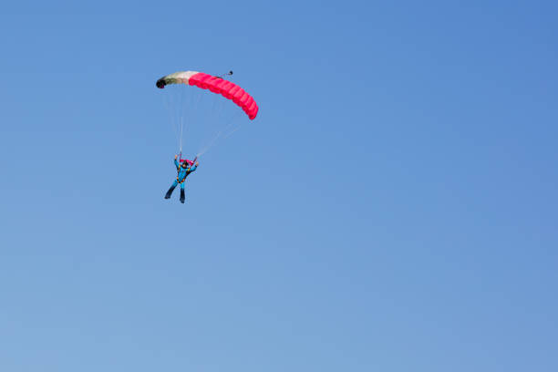 istock parachutist on background clear blue sky 870493026