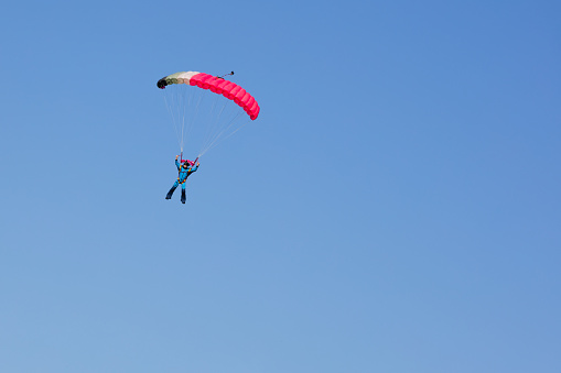 parachutist on background clear blue sky