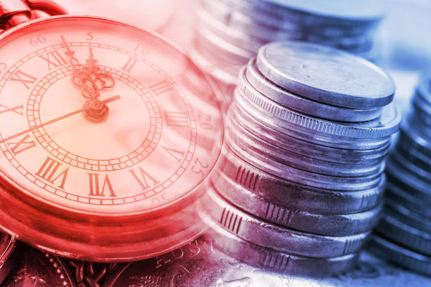 time is money, time value of money concept : coins and vintage brass pocket watch, idea of time which is a valuable commodity or resource and it's better to do work or things as quickly as possible. - stock market data insurance savings finance imagens e fotografias de stock