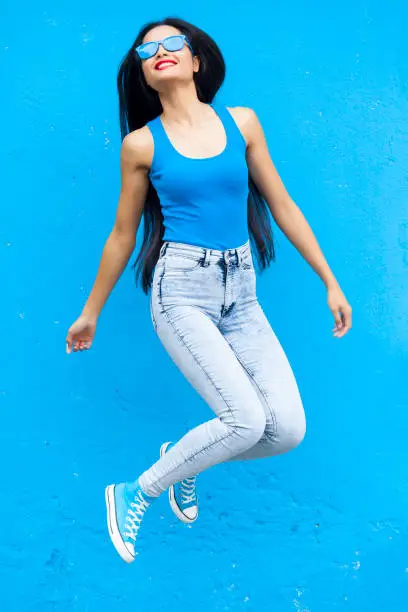 Photo of Woman in blue colour jumping