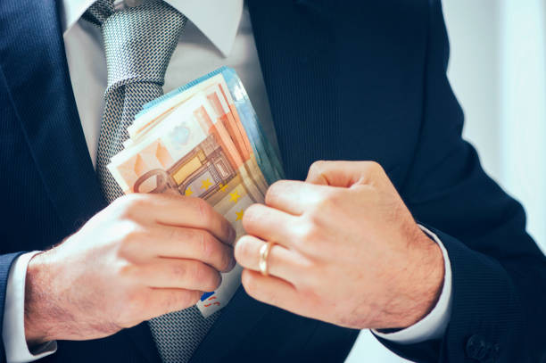 istock businessman putting money in his pocket 870500054