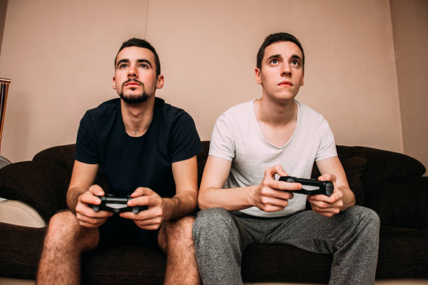 istock Playing video game at home 870505640