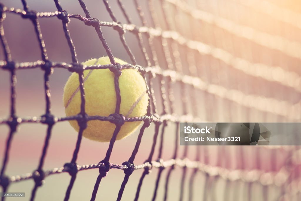 Tennis ball hitting the tennis net at tennis court with copy space. Tennis Stock Photo