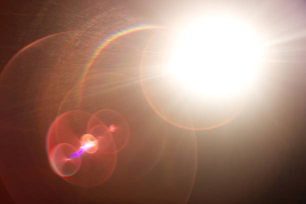 istock Lens flare light over black background. 870506554