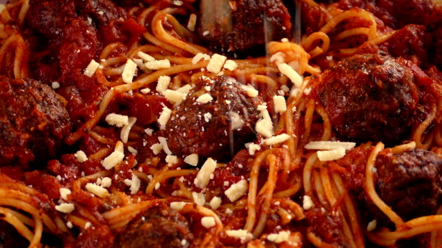Grated Cheese Sprinkled On Spaghetti And Meatballs