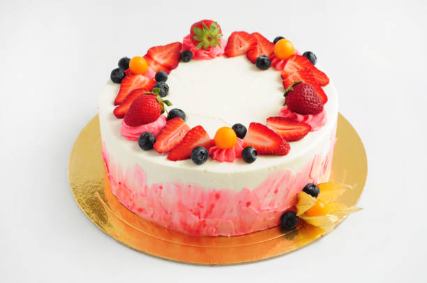 istock Cake with whipped cream, fresh strawberries, blueberries and physalis. 870510474