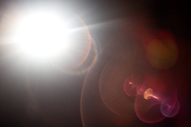 istock Lens flare light over black background. 870510484