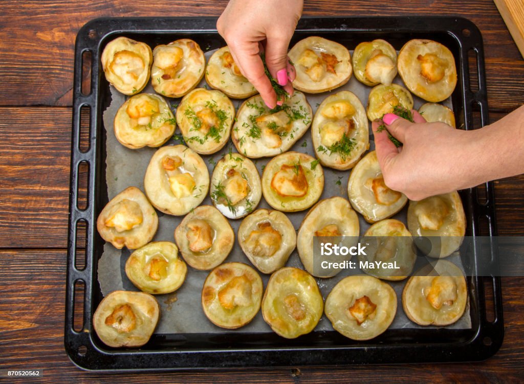 baked potatoes in a baking sheet on a wooden table top view baked potatoes in a baking sheet on a wooden table top view background Potato Salad Stock Photo