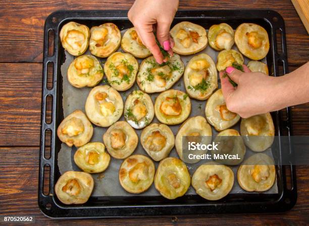 Baked Potatoes In A Baking Sheet On A Wooden Table Top View Stock Photo - Download Image Now