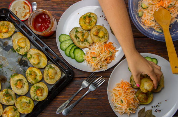 istock baked potatoes in a baking sheet on a wooden table top view 870521436