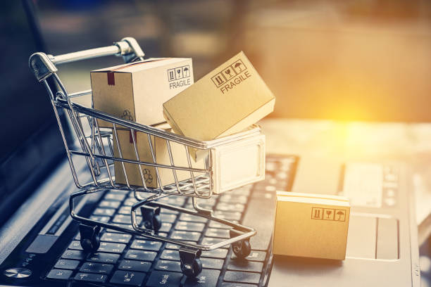 istock Paper boxes in a shopping cart on a laptop keyboard. Ideas about e-commerce, e-commerce or electronic commerce is a transaction of buying or selling goods or services online over the internet. 870527480