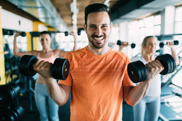 istock Young attractive man doing exercises in gym 870527746