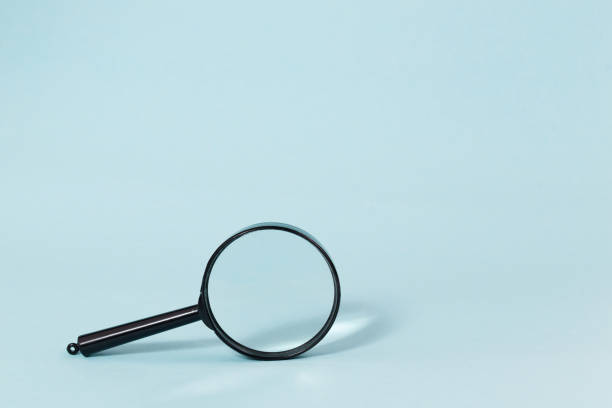 istock Magnifying glass on a pastel blue background 870528256