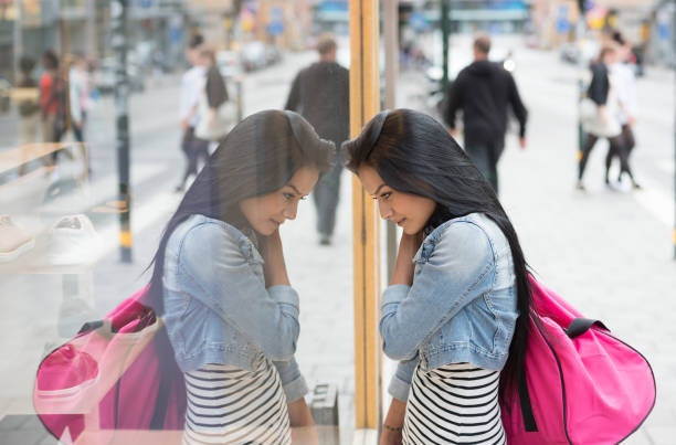 istock Smiling woman looking in shop window 870528598