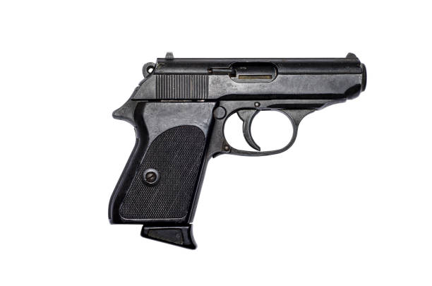 Used black metal pistol gun on white background stock photo