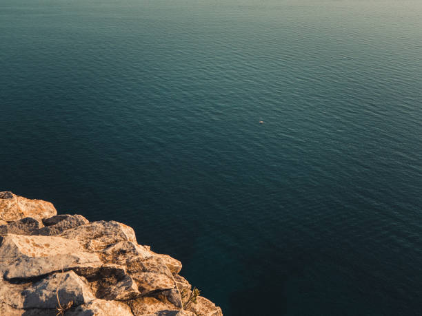 istock Mediterranean Sea with small sailing boat and rocks 870539026