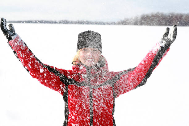istock Mature woman having fun in the snow. 870541788