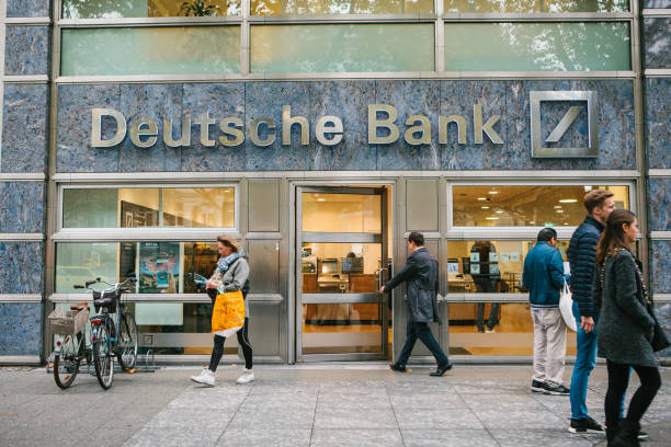 Unknown man walks into the beautiful glass office of Deutsche Bank stock photo