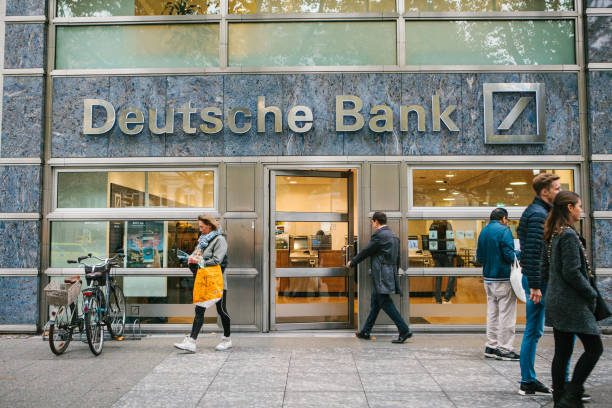 unknown man walks into the beautiful glass office of deutsche bank - going into imagens e fotografias de stock