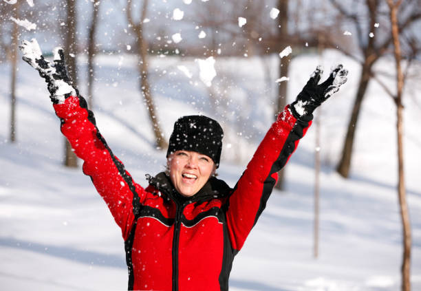 istock Mature woman having fun in the snow. 870542034