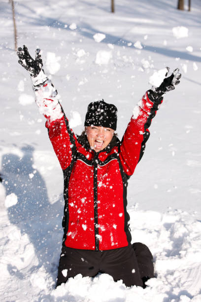 istock Mature woman having fun in the snow. 870542090