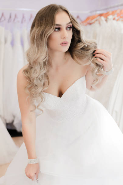 istock Bride woman trying dress 870545756