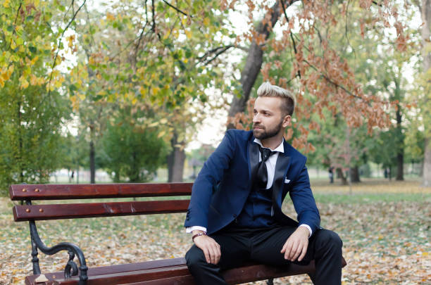 istock Businessman sitting in park 870548818