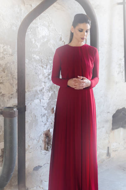 istock Sad woman in long red dress 870548978