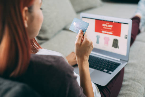 Online shopping Woman making online payment via laptop at home. clothing store credit card stock pictures, royalty-free photos & images