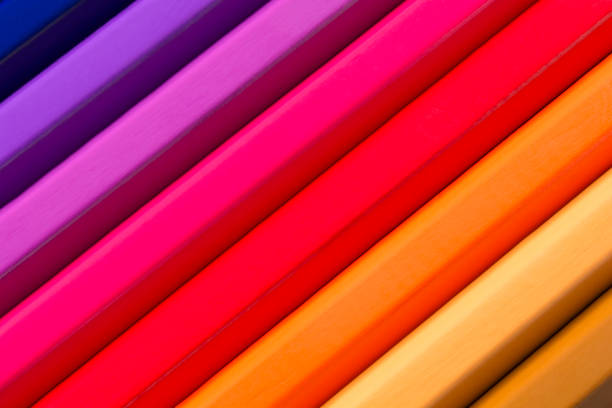 Wooden colored pencils lined up in a row on tray
