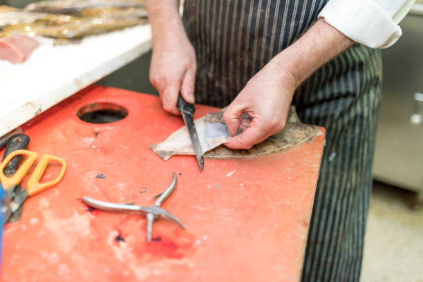istock British fish monger fillets a dover sole and pulls it