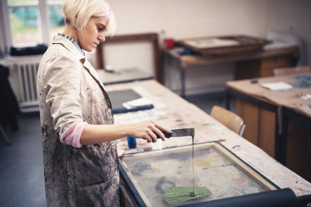istock Woman in printing workshop preparing colors 870562548