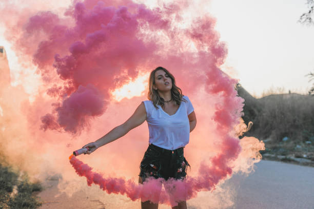 istock Woman in pink smoke 870565002