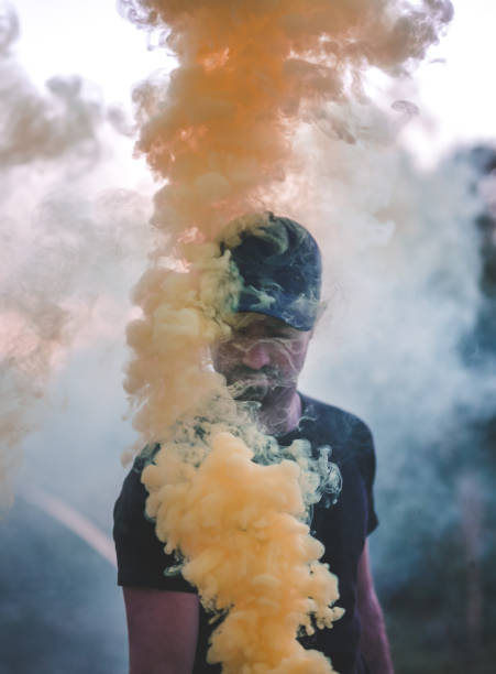 istock Man in yellow smoke 870565028