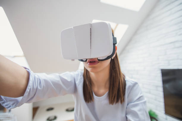 istock Brunette girl playing with virtual reality 870565370