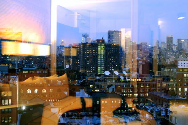 istock NYC skyline and its reflection on the window of a room 870565578