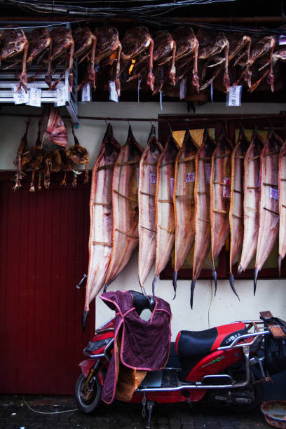 Chinese grocery store with smoked fish and meat. shopping street in the old quarter of the city