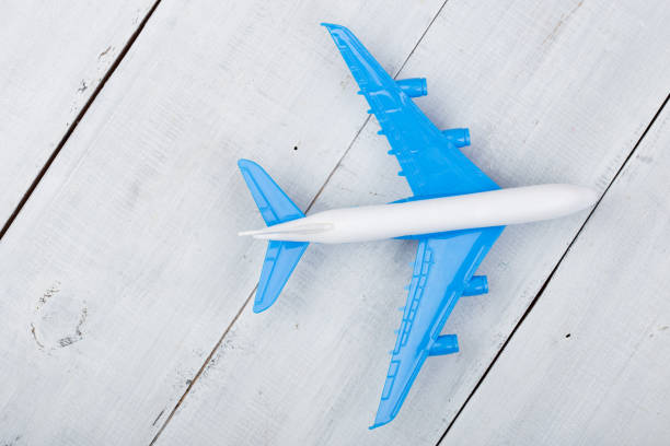 istock Toy plane on white wooden background. Top view 870565908