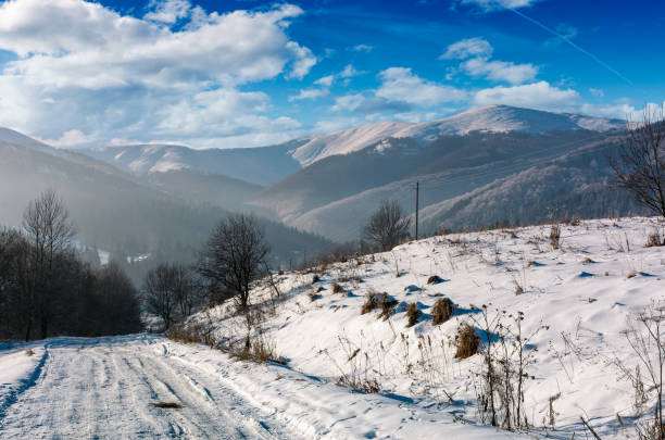 istock rural road in snowy mountainous area 870572106