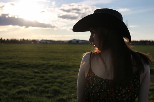 istock girl outdoor field sunset texas hat 870575512