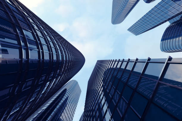 istock 3d rendering Low angle view of skyscrapers. Skyscrapers at sunset looking up perspective. Bottom view of modern skyscrapers in business district in evening light at sunset. Business concept of success industry tech architecture. 870581812