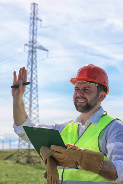 istock Electrician working in a helmet wearing gloves 870581948