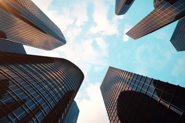 istock 3d rendering Low angle view of skyscrapers. Skyscrapers at sunset looking up perspective. Bottom view of modern skyscrapers in business district in evening light at sunset. Business concept of success industry tech architecture. 870582402