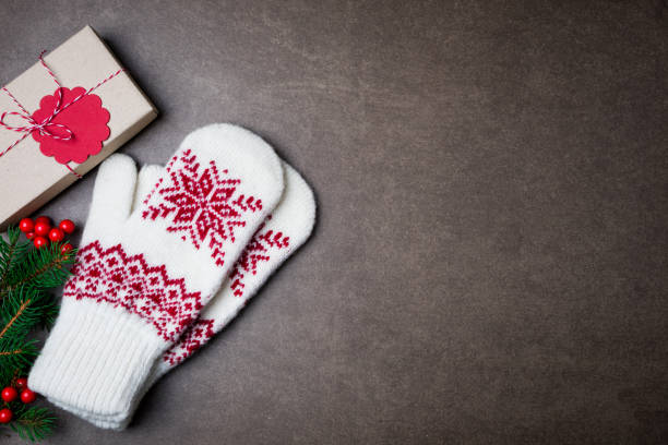 istock Christmas background with gift boxs, christmas tree, mittens and decorations on dark background 870582672