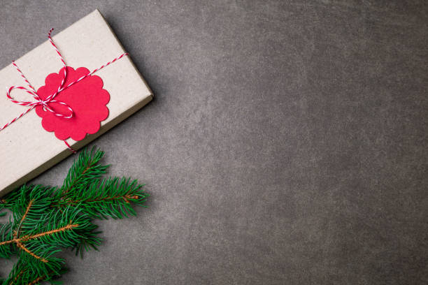 istock Christmas background with gift box, christmas tree and decorations on dark background 870584796