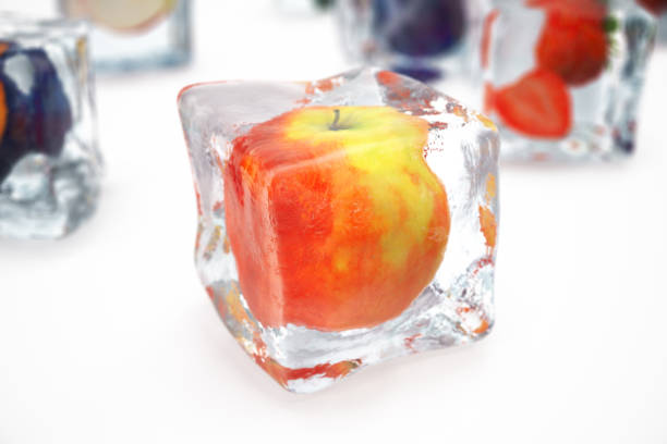 istock Apple in ice cube isolated on white with depth of field effects. Ice cubes with fresh berries. Berries fruits frozen in ice cubes, 3D rendering 870584818