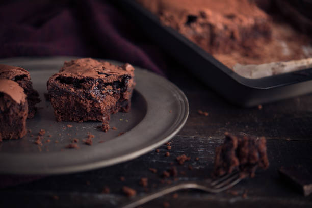 istock Brownie chocolate cake on dark moody background 870588930
