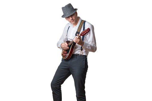 Man with hat und sunglasses plays Mandolin isolated on white